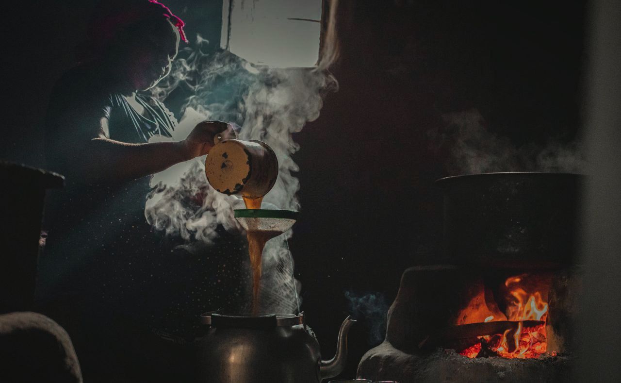 Warm kitchen scene with a pot over an open flame